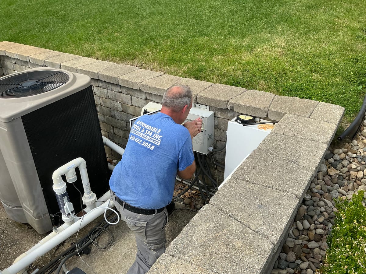 An Affordable Pool and Spa technician at work on a pool system